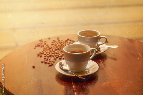 Hot coffee and coffee beans on the table