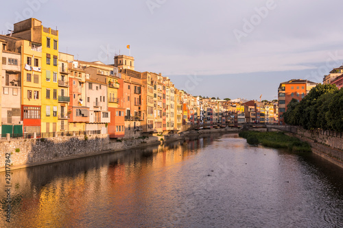 Colorful yellow and orange houses reflected in water river Onyar, in Girona, Catalonia, Spain. © Jorge Fuentes