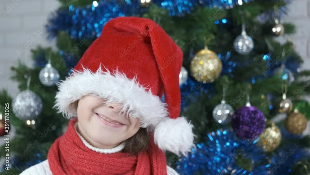 Playful Christmas. Cheerful little girl wearing a santa claus hat. Playful Christmas. Cheerful little girl wearing a santa claus hat.