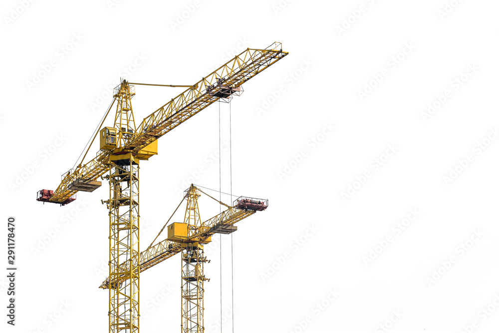 Yellow construction crane on a white isolated background builds multi-storey residential buildings using modern technologies of metal, concrete and brick according to the architectural design