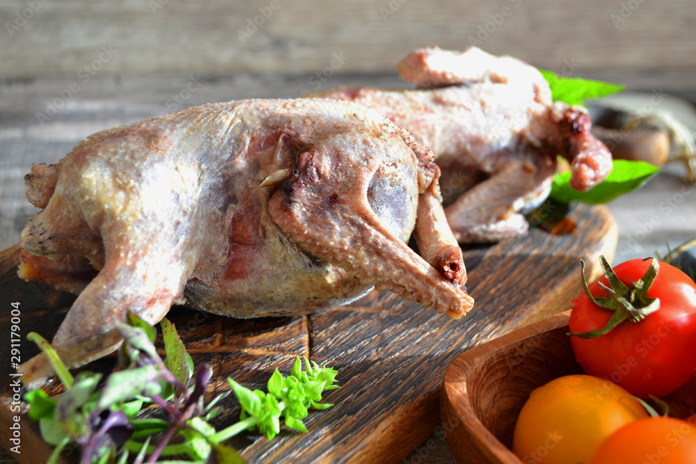 Rustic russian food. Preparing woodcock for cooking on wooden cutting board Rustic russian food. Preparing woodcock for cooking on wooden cutting board