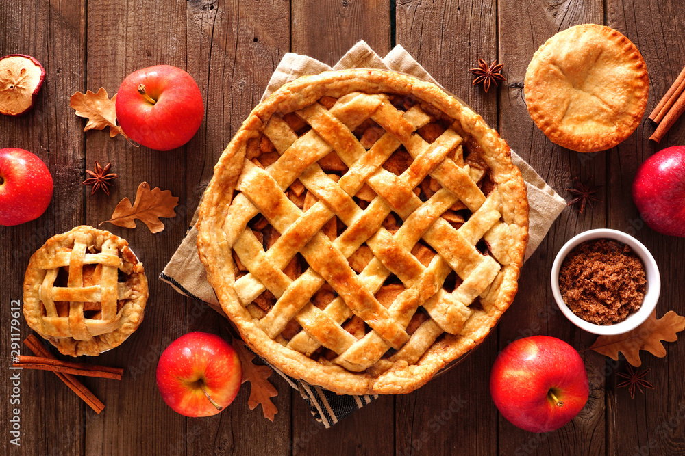 Homemade autumn apple pies, overhead view table scene with a rustic wood background Homemade autumn apple pies, overhead view table scene with a rustic wood background