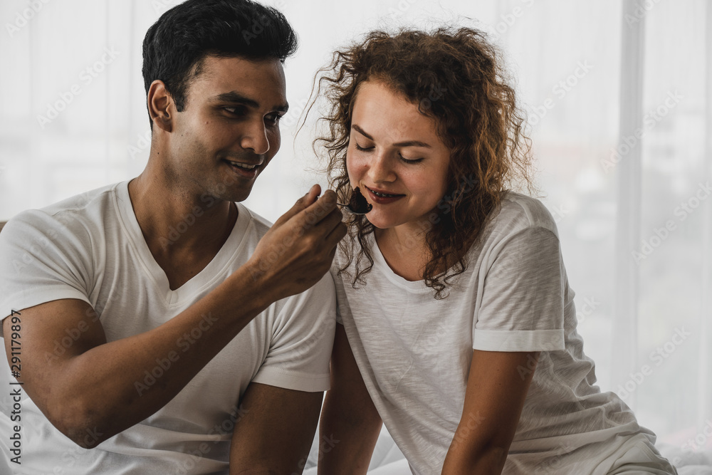 Obraz premium Couple love choosing clothes from wardrobe in bedroom. couple love lifestyle, clothing, fashion, family style and people concept.