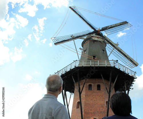 couple observing an old windmill