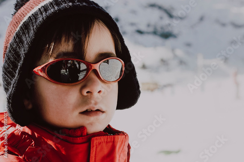 Kid playing with the snow in winter