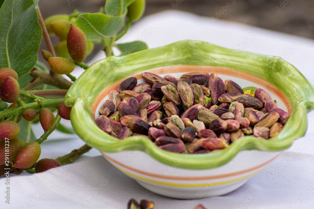 Sweet, delicate and fragrant nuts, Bronte pistachios with  brilliant green colour, ingredient for Italian cuisine, ice creams, cakes, pesto