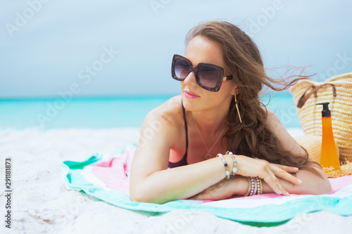 modern middle age woman looking into distance and sun bathing