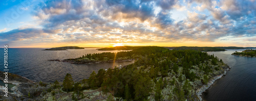 Panorama of Karelia at sunrise. Islands in lake Ladoga. Top view of the sunrise over the lake. Skerries in lake Ladoga. Northern nature. Trip to Russia. Natural attractions of Russia. photo