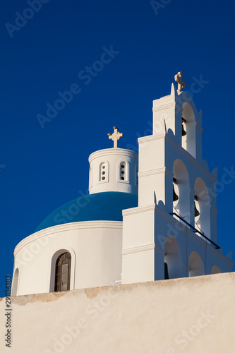 Dome and bell tower of the Church of Panagia Platsani located in Oia city at Santorini Island in a beautiful early spring day