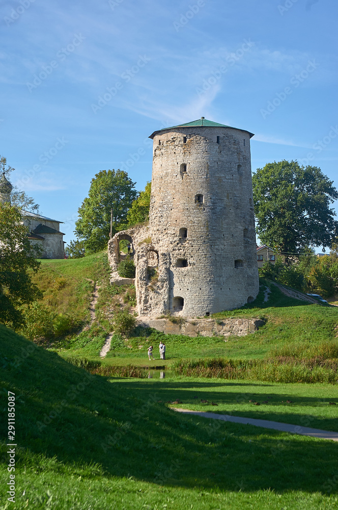 View of the Gremyachaya tower over the Pskova river. Summer landscape.