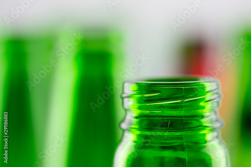 Colorful empty beer bottles, lots of empty beer bottles. Closeup, daylight. Beer's over, party's over.