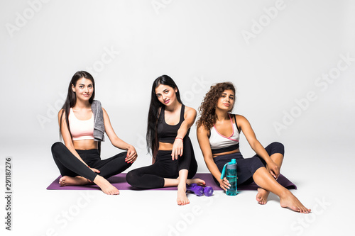 Three smile young three girls laydown on yoga mat and relax and looking teacher yoga in class with relax emotion.