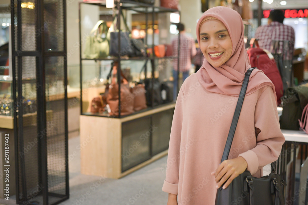 Portrait of young asian muslim women shopping in mall. Portrait of young asian muslim women shopping in mall.
