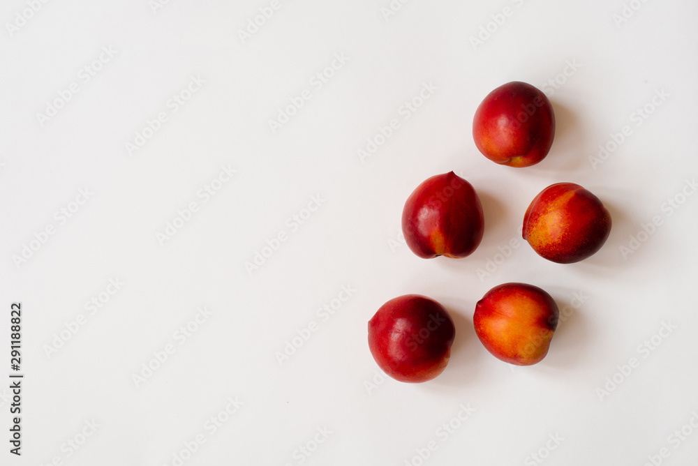 Fresh organic nectarines lie on a white background. Copy space. The concept of healthy and healthy food, fruit Fresh organic nectarines lie on a white background. Copy space. The concept of healthy and healthy food, fruit