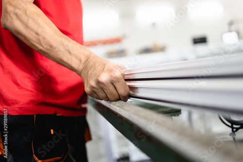 Manual worker assembling PVC doors and windows. Manufacturing jobs. Selective focus. Factory for aluminum and PVC windows and doors production.