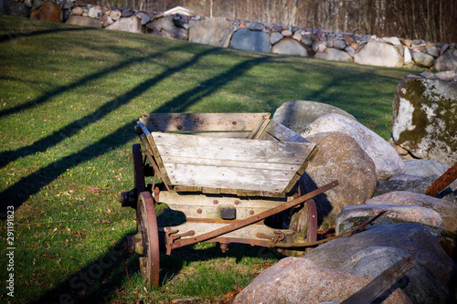 Old wooden traler aside large rocks