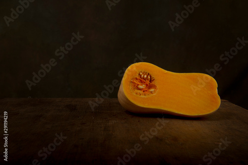 A small orange pumpkin cut in half