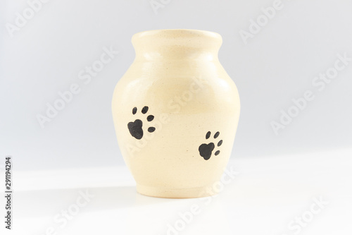 small vase with cat paw prints made of beige clay covered with transparent glaze