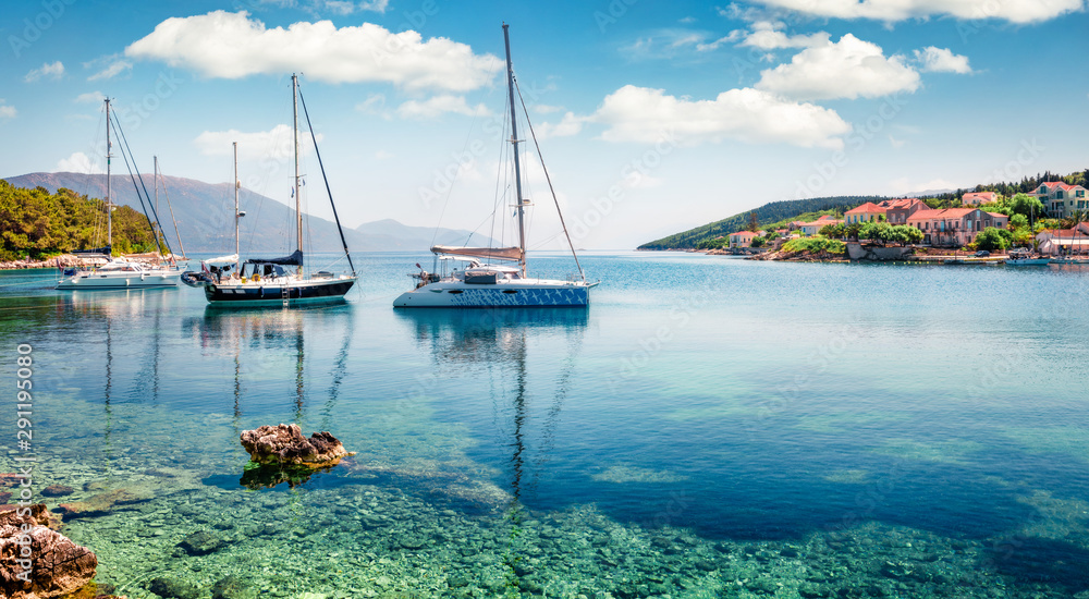 Fototapeta premium Captivating morning view of Fiskardo port. Picturesque spring seascape of Ionian Sea. Colorful morning scene of Kefalonia island, Greece, Europe. Traveling concept background.