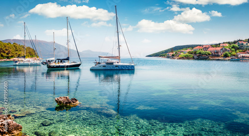 Captivating morning view of Fiskardo port. Picturesque spring seascape of Ionian Sea. Colorful morning scene of Kefalonia island, Greece, Europe. Traveling concept background.