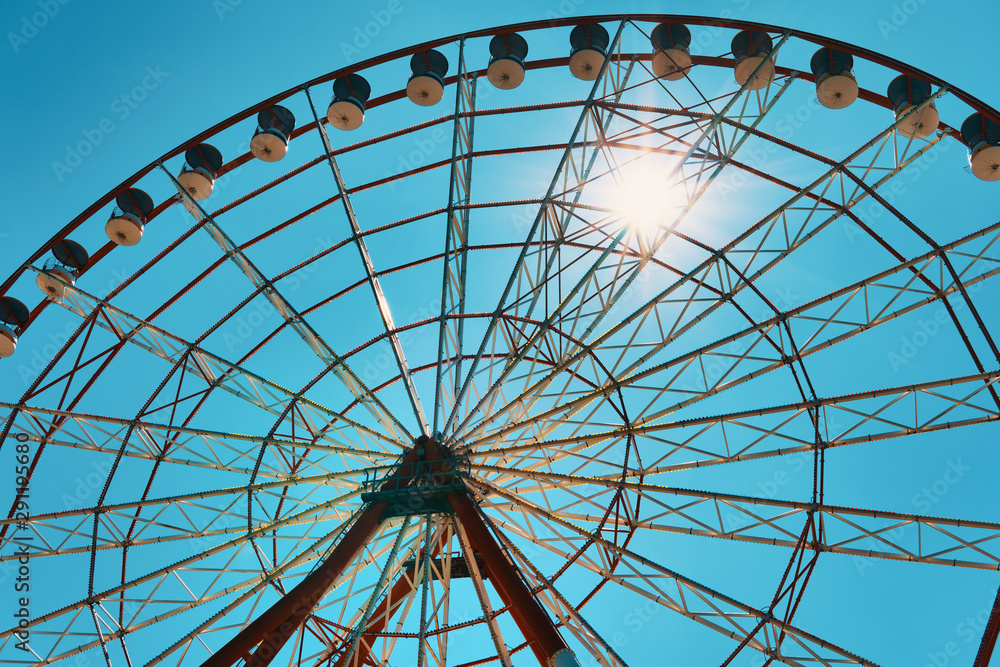 big wheel against the background of the blue sky and sunshine.