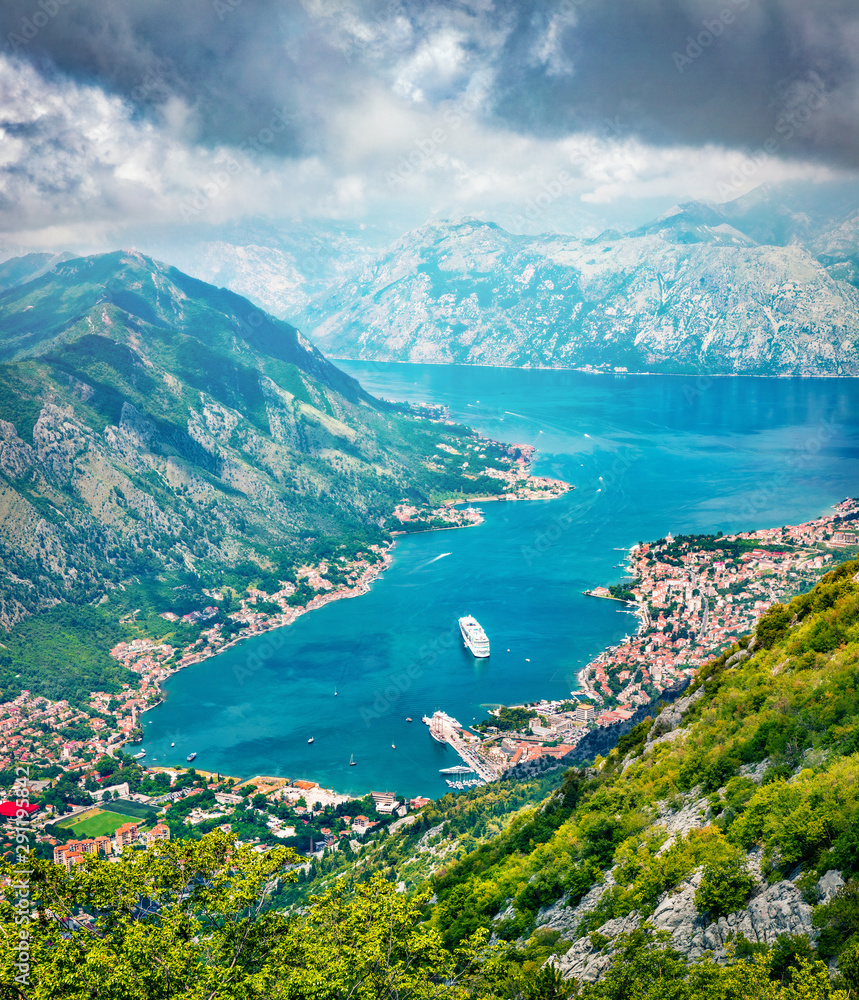 Fantastic summer cityscape of Kotor port. Aerial morning view of Kotor bay and  limestone cliffs of Mt. Lovcen. Sunny Adriatic seascape. Beautiful world of Mediterranean countries. 