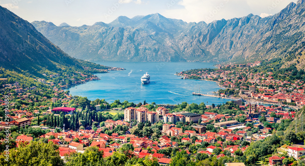 Bright summer cityscape of Kotor port. Aerial morning view of Kotor bay and  limestone cliffs of Mt. Lovcen. Sunny Adriatic seascape. Beautiful world of Mediterranean countries. 