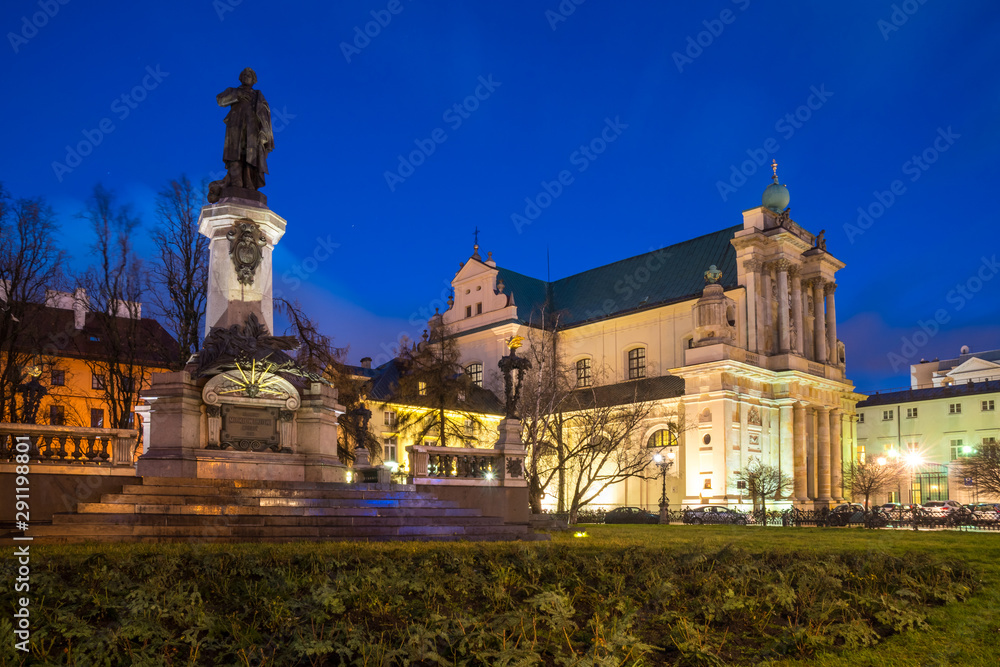 Mickiewicz Monument and Church of the Assumption of the Virgin Mary and of St. Joseph known as the Carmelite Church at night.