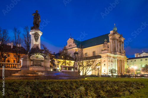 Mickiewicz Monument and Church of the Assumption of the Virgin Mary and of St. Joseph known as the Carmelite Church at night.