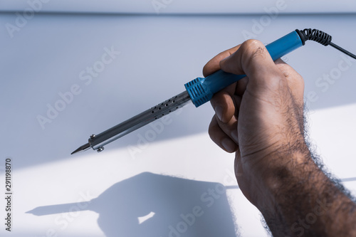 Soldering iron on a white background photo