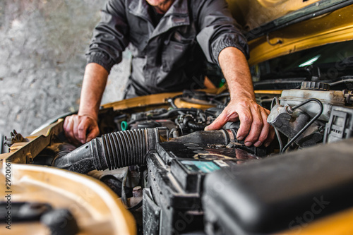  Car service worker repairing vehicle