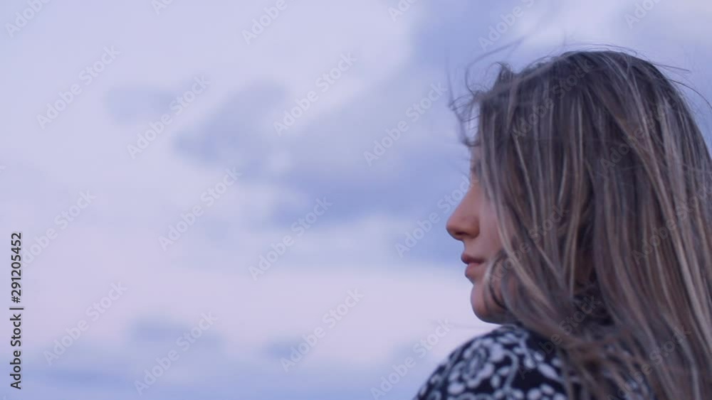 Beautiful sad young woman on the beach through autumn Beautiful sad young woman on the beach through autumn