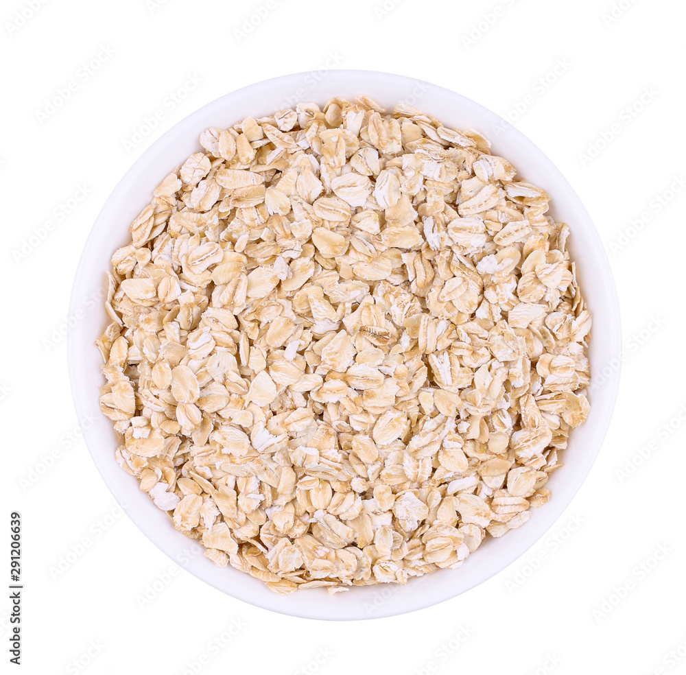 The white plate with uncooked oatmeal. Isolated picture. The white plate with uncooked oatmeal. Isolated picture.