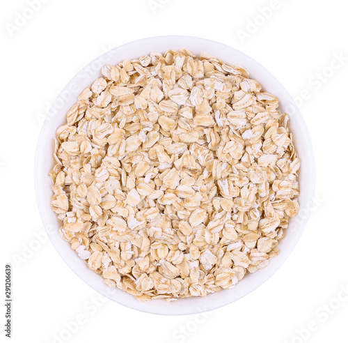The white plate with uncooked oatmeal. Isolated picture.