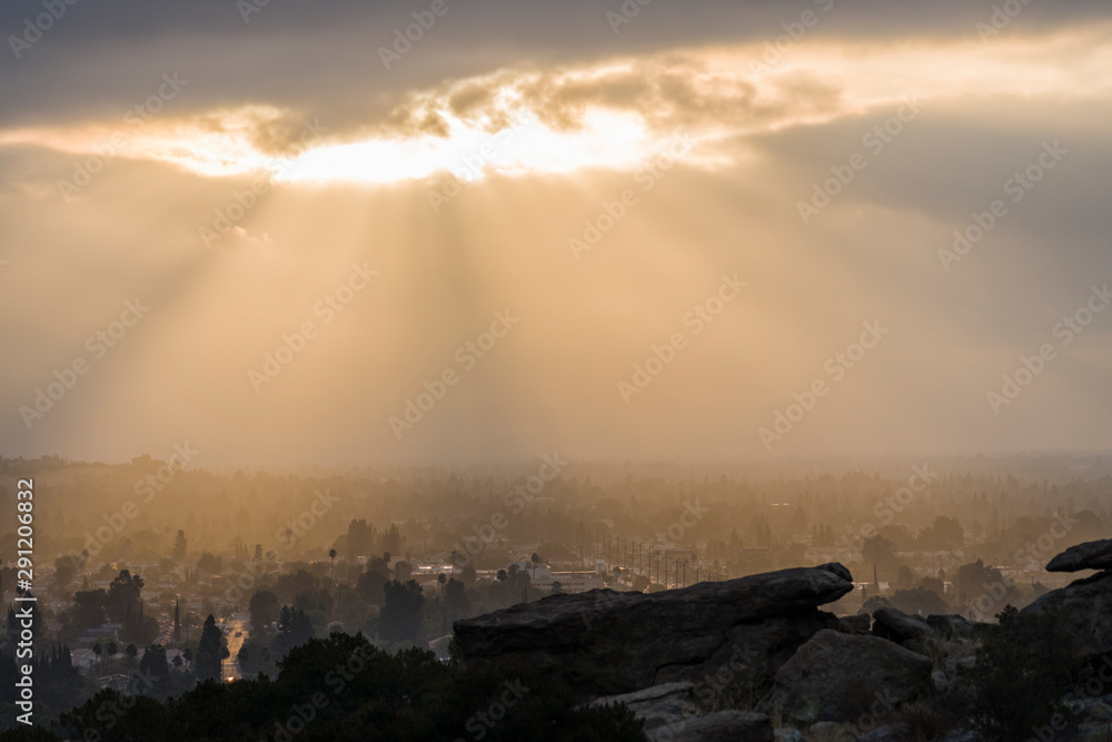 Sun bursting through low clouds near Chatsworth Park South in the San Fernando Valley area of Los Angeles, California. Sun bursting through low clouds near Chatsworth Park South in the San Fernando Valley area of Los Angeles, California.