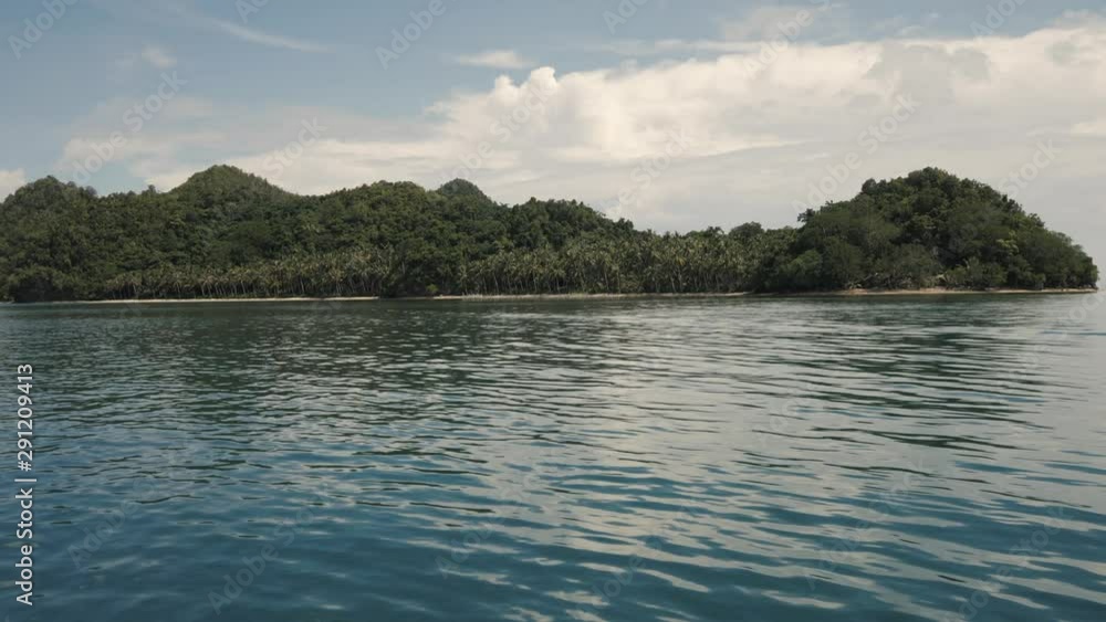 Seascape from sailing boat, tropical island with palm trees and white sand beach Seascape from sailing boat, tropical island with palm trees and white sand beach