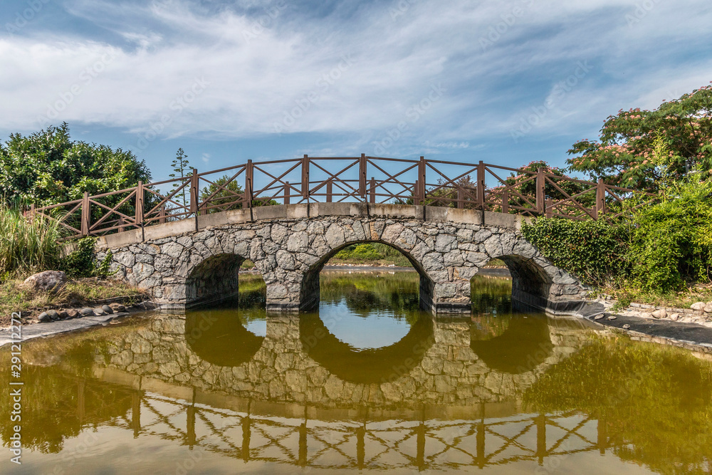 Reflection of old stone bridge
