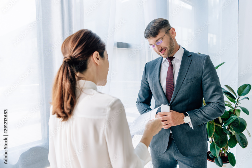 back view of journalist talking with businessman in formal wear back view of journalist talking with businessman in formal wear