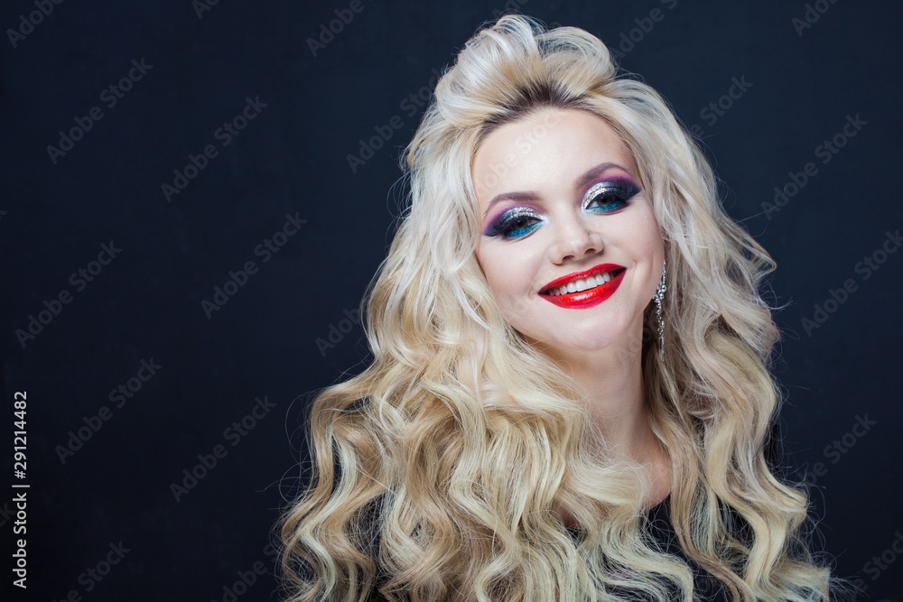 Portrait of a young luxurious blonde with long curls. Portrait of a young luxurious blonde with long curls.