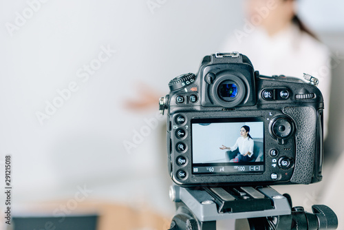 selective focus of digital camera shooting journalist in office