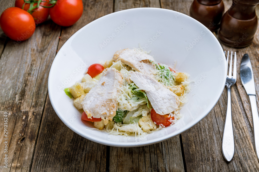Salad caesar with chicken on white plate Salad caesar with chicken on white plate