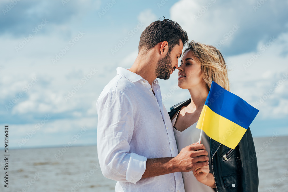 attractive woman and handsome man holding ukrainian flag outside attractive woman and handsome man holding ukrainian flag outside