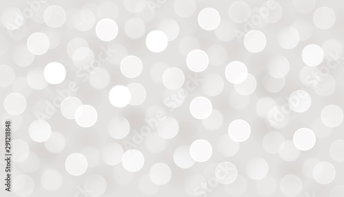 Vector defocused bokeh lights. Silver glitter Christmas abstract background.