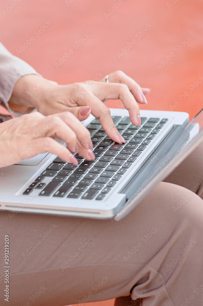 Woman typing on keyboard of computer laptop Woman typing on keyboard of computer laptop