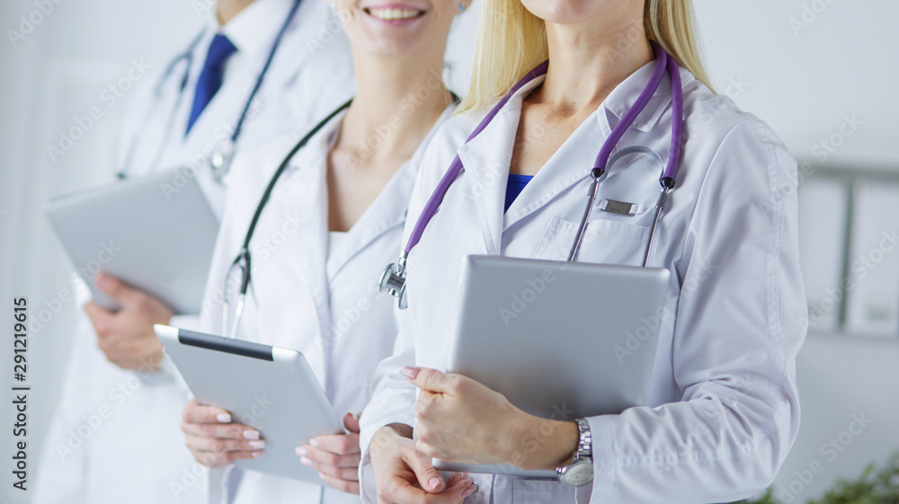 Smiling doctors all standing together as they work Smiling doctors all standing together as they work