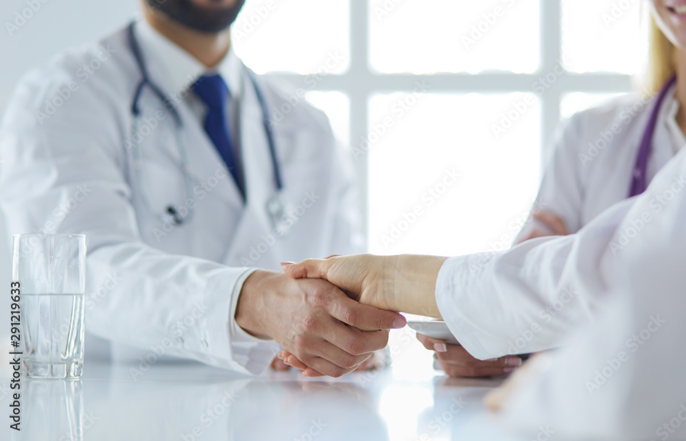 Doctor shaking hands with a male patient in the office Doctor shaking hands with a male patient in the office