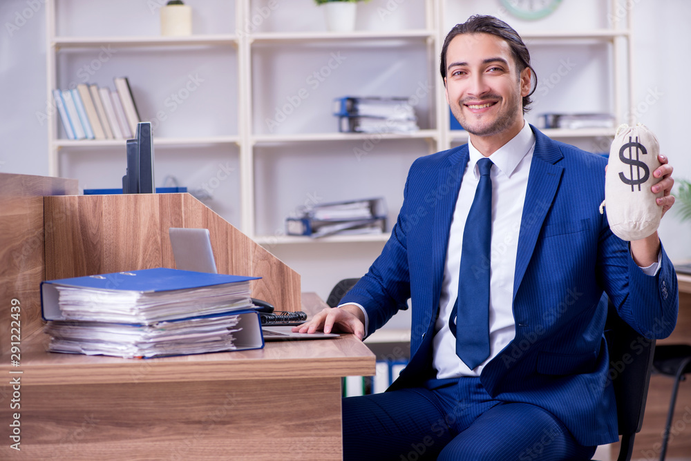 Young handsome businessman working in the office Young handsome businessman working in the office