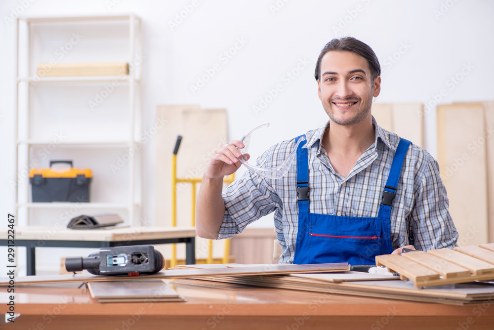 Young male carpenter working indoors Young male carpenter working indoors
