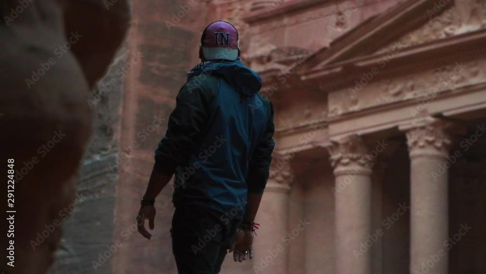 man walking in front of petra's treasure man walking in front of petra's treasure