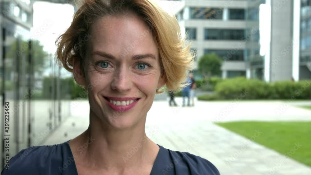 Close up of a beautiful smiling blond woman in the city. Close up of a beautiful smiling blond woman in the city.